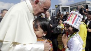 Pope Francis is greeted by young children in traditional clothes upon his arrival at Yangon's airport, Myanmar, Monday, Nov. 27, 2017. The pontiff is in Myanmar for the first stage of a week-long visit that will also take him to neighboring Bangladesh. (AP Photo/Andrew Medichini)